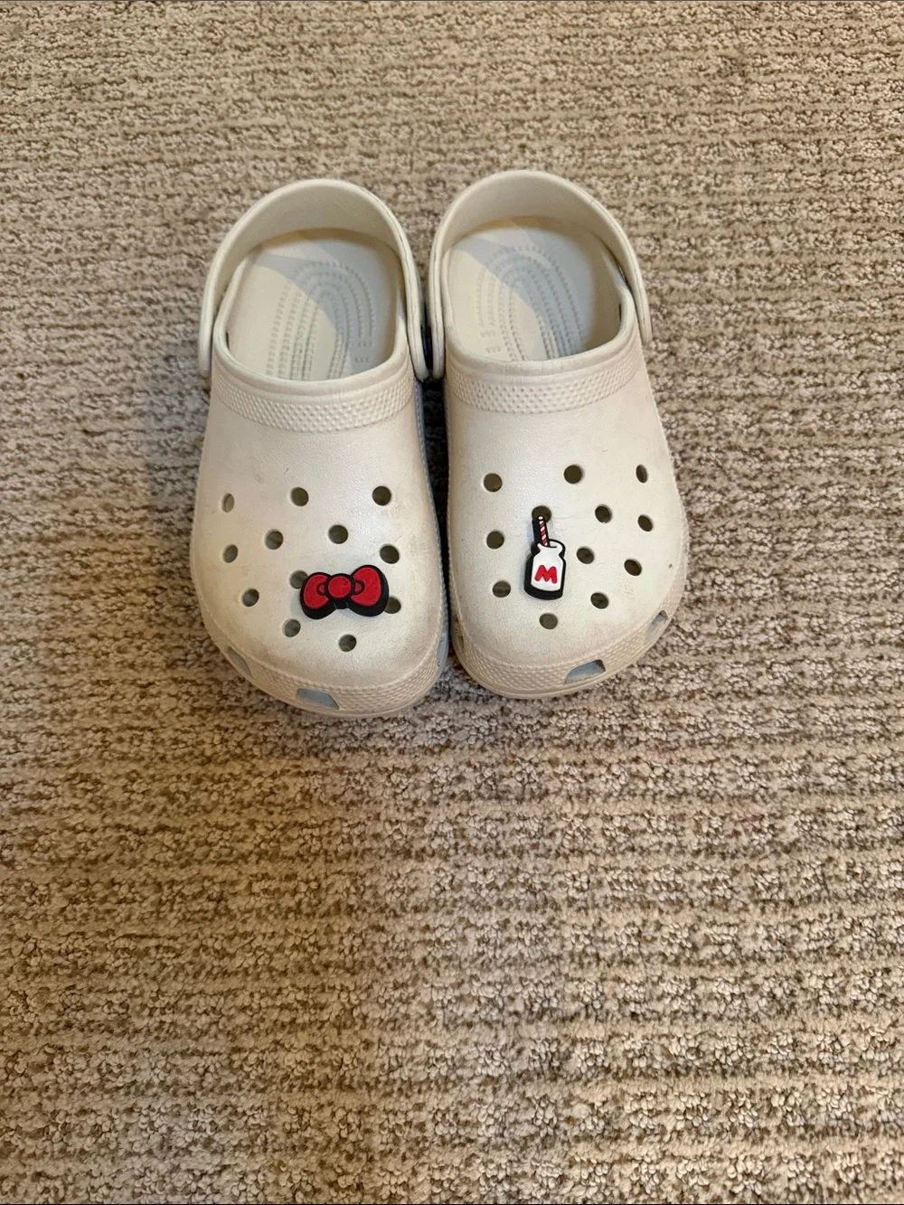CROCS Kids Cream Slip-On Clogs with Red Charm Accents